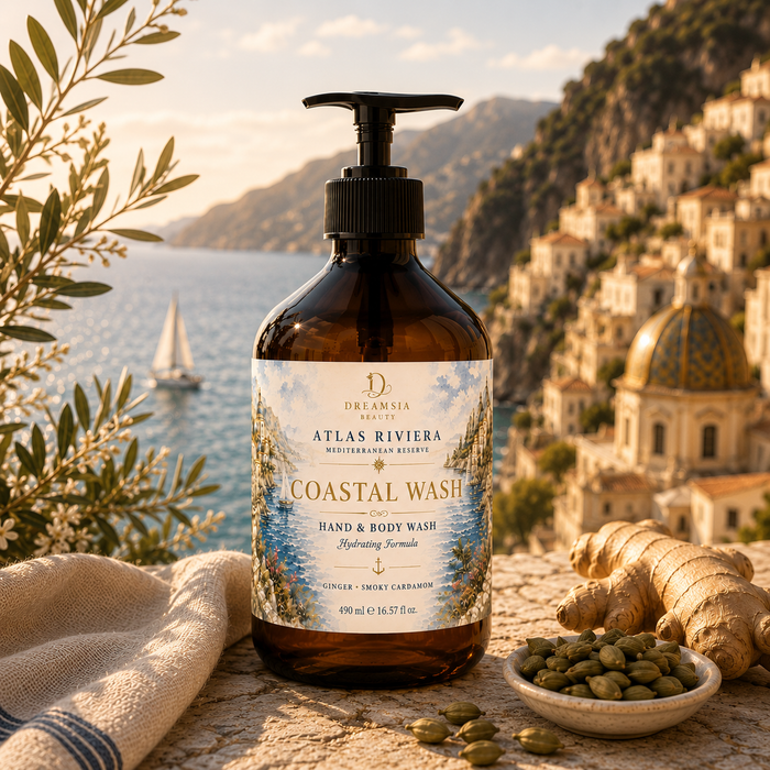 Atlas Riviera Coastal Wash Hand & Body Wash amber bottle beside fresh ginger and cardamom pods with a sailboat and domed coastal town behind